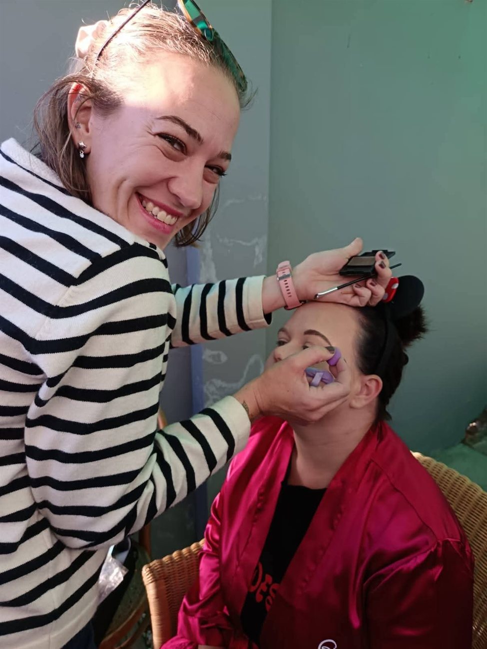 Rochelle applying makeup for a client